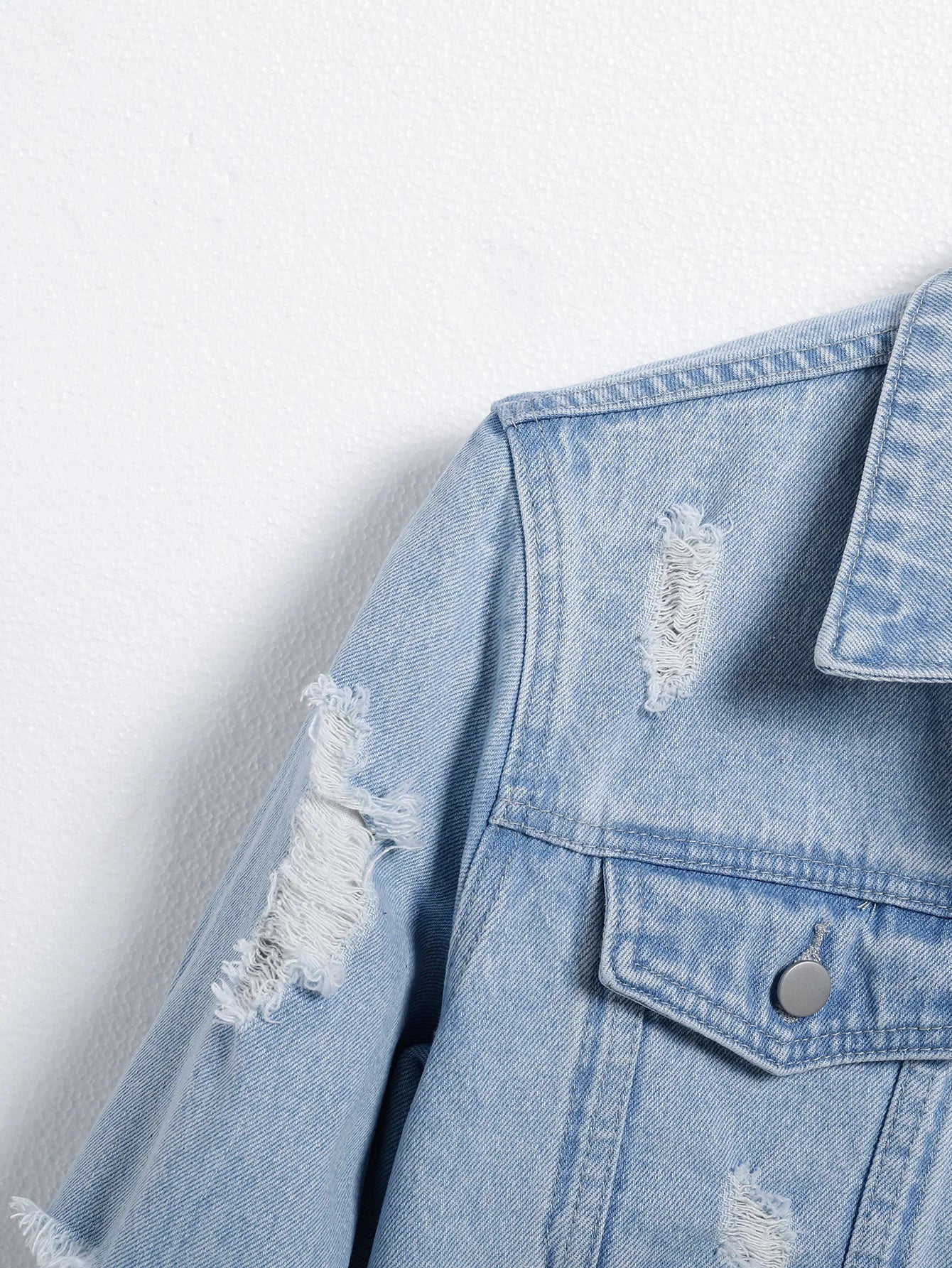 Men's light blue ripped denim jacket. Stylish and trendy. Street casual.