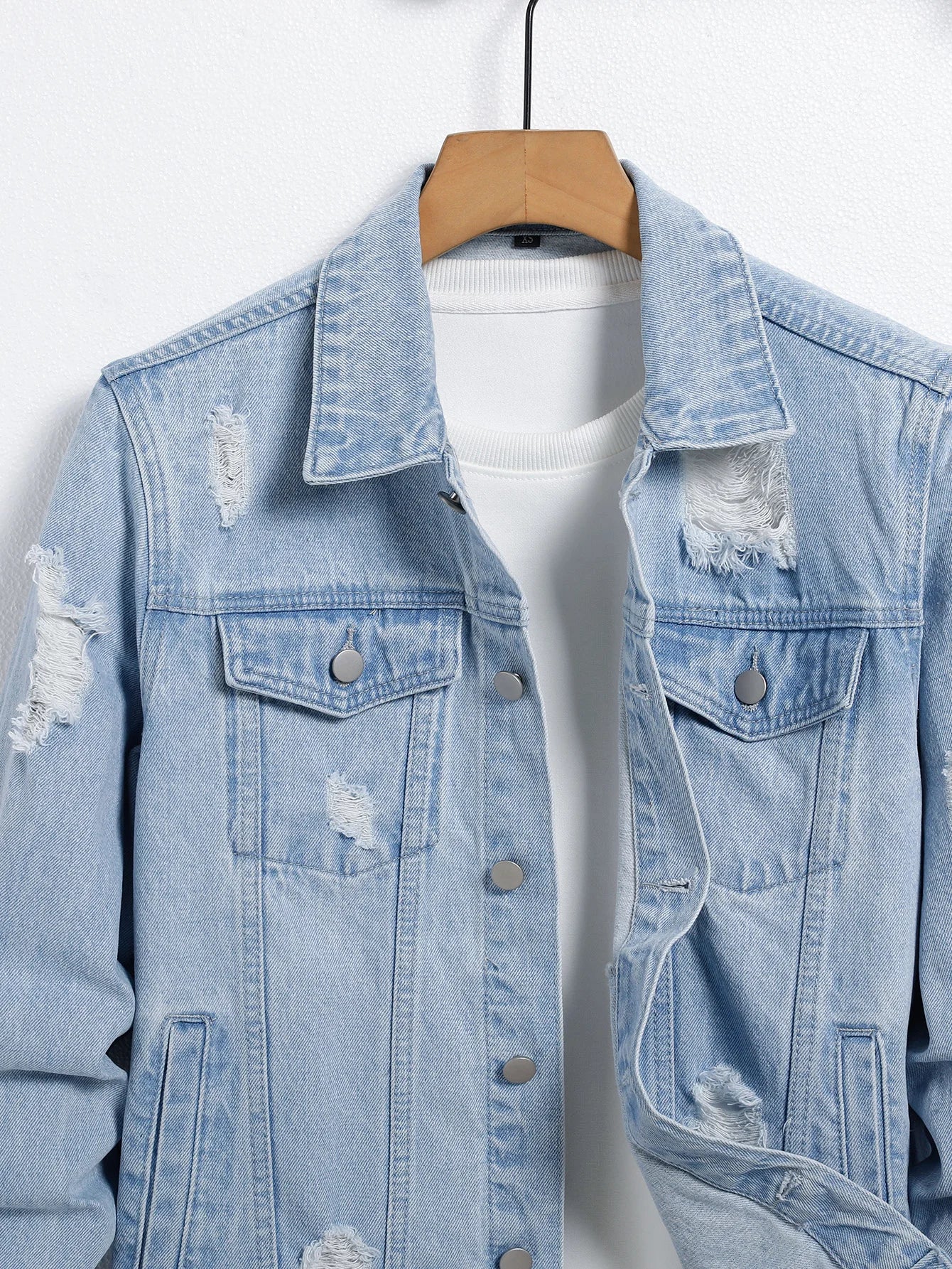 Men's light blue ripped denim jacket. Stylish and trendy. Street casual.