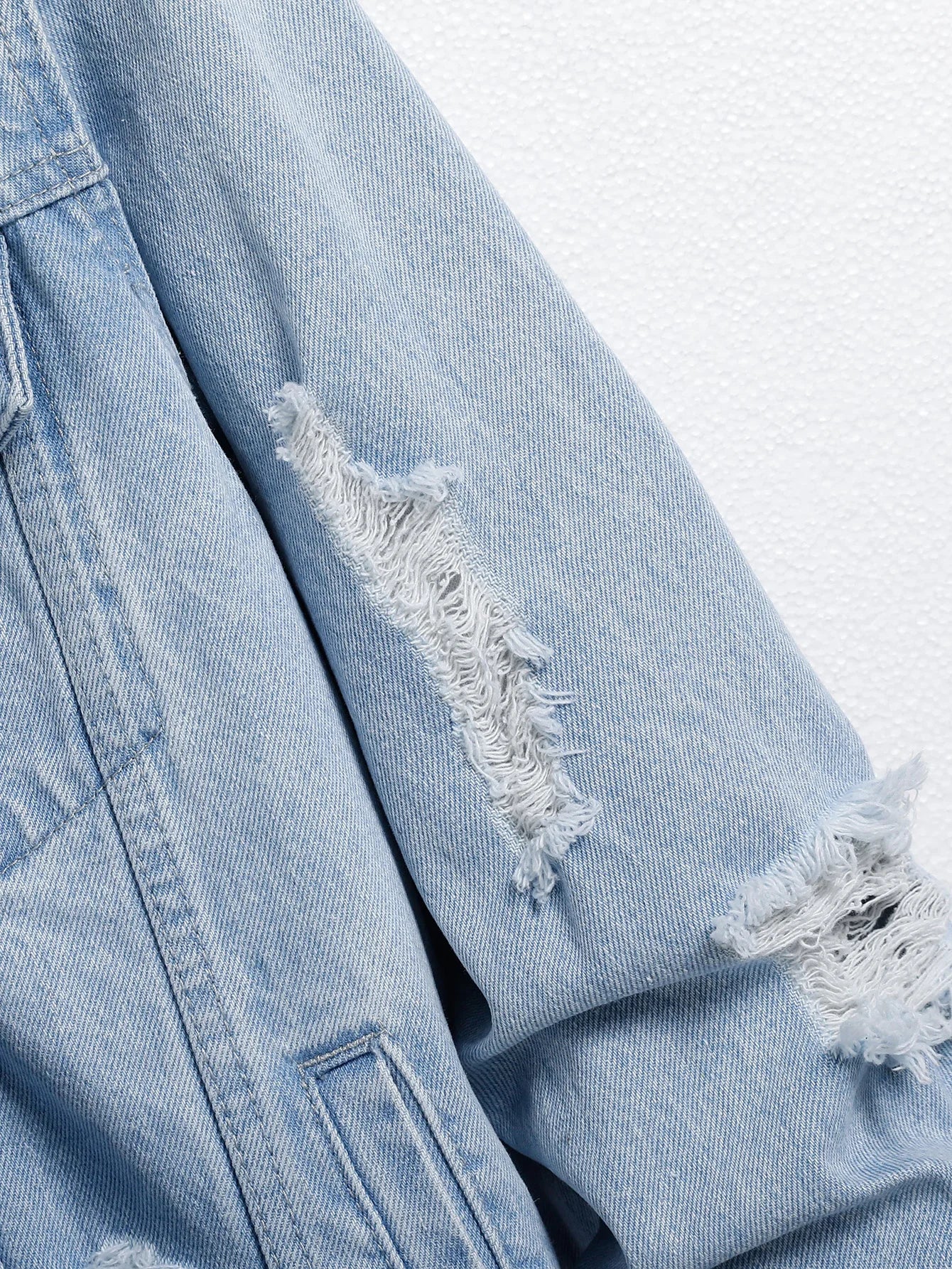 Men's light blue ripped denim jacket. Stylish and trendy. Street casual.