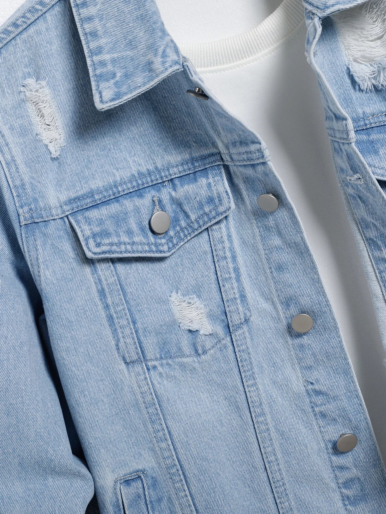 Men's light blue ripped denim jacket. Stylish and trendy. Street casual.