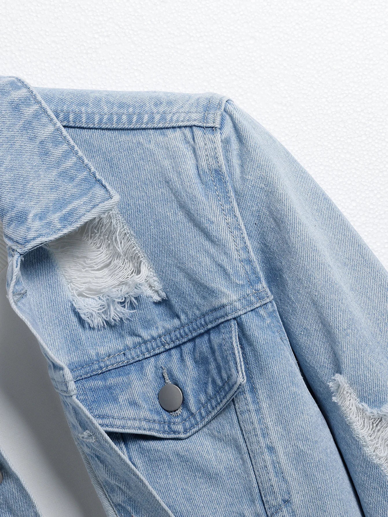 Men's light blue ripped denim jacket. Stylish and trendy. Street casual.